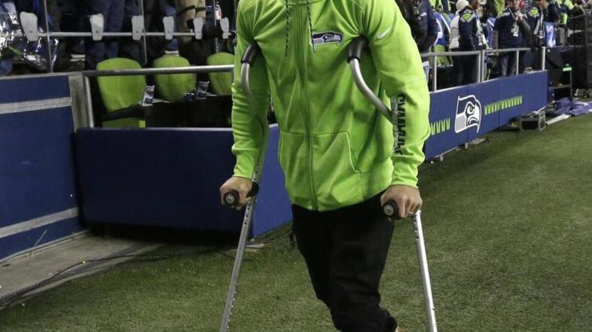 Injured free safety Earl Thomas, wearing a fur hat that is a gift from Seahawks fans in Russia, walks off the field late in the first half of Saturday’s wild-card playoff game against Detroit at CenturyLink Field.