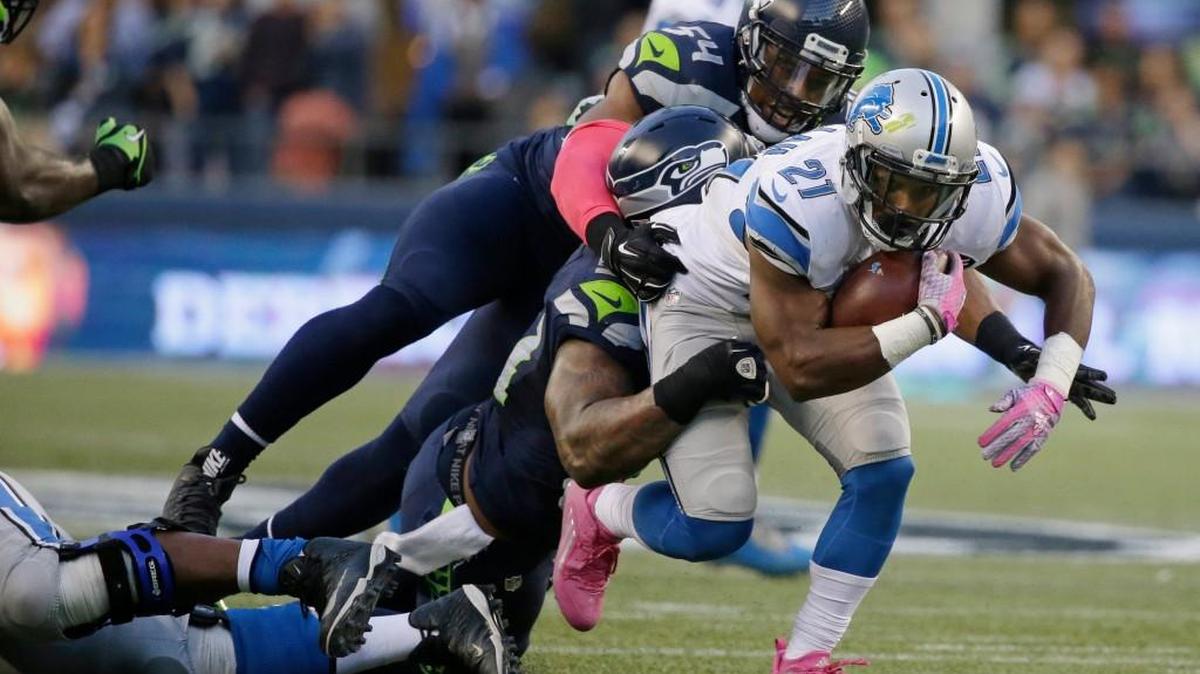 
Detroit Lions running back Ameer Abdullah (21) carries the ball as he is tackled by Seattle Seahawks middle linebacker Bobby Wagner (54) and outside linebacker Bruce Irvin, lower left, in the first half of an NFL football game, Monday, Oct. 5, 2015, in Seattle.
