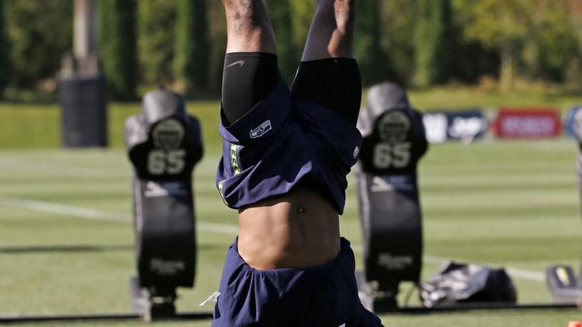 
Seahawks All-Pro LB Bobby Wagner walks through a handstand between drills at the final day of their training camp on Thursday in Renton. The morning had a last-day-of-school feel to it.
