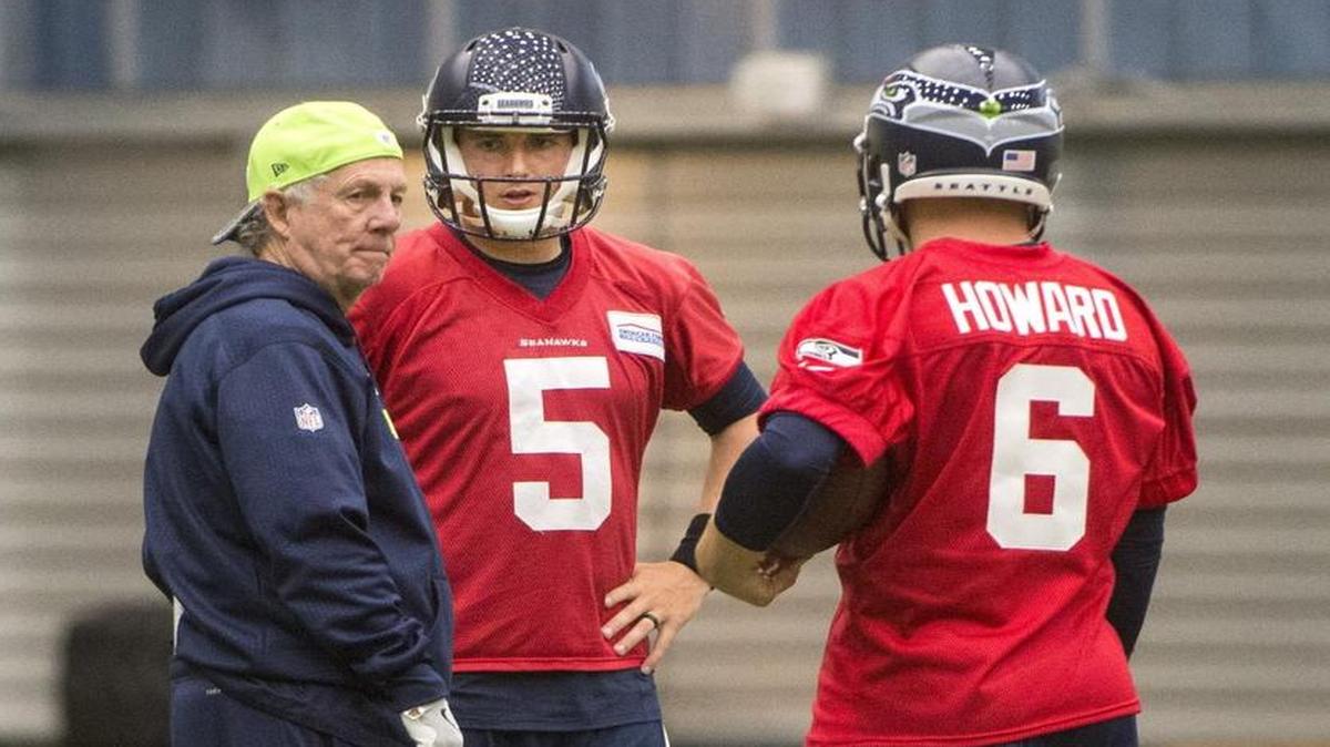 Seattle quarterbacks coach Carl Smith meets with backups Jake Heaps and Skyler Howard, right, Friday at minicamp.