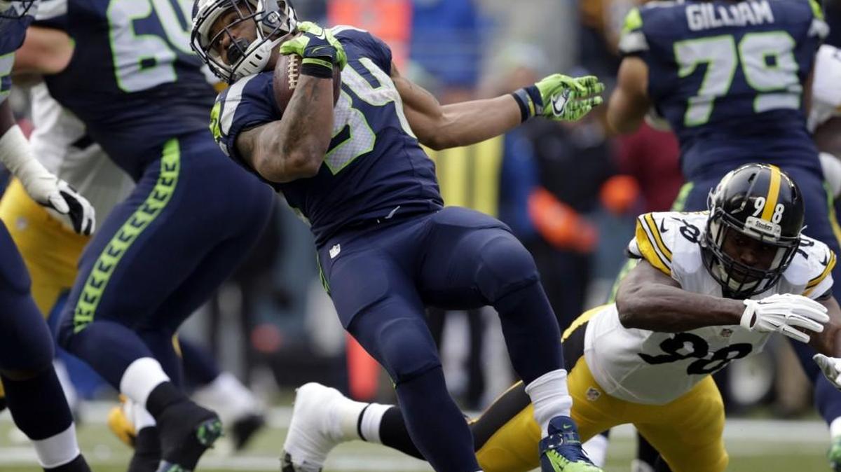 Seattle Seahawks' Thomas Rawls, left, rushes past Pittsburgh Steelers' Vince Williams in the first half of an NFL football game, Sunday, Nov. 29, 2015, in Seattle.