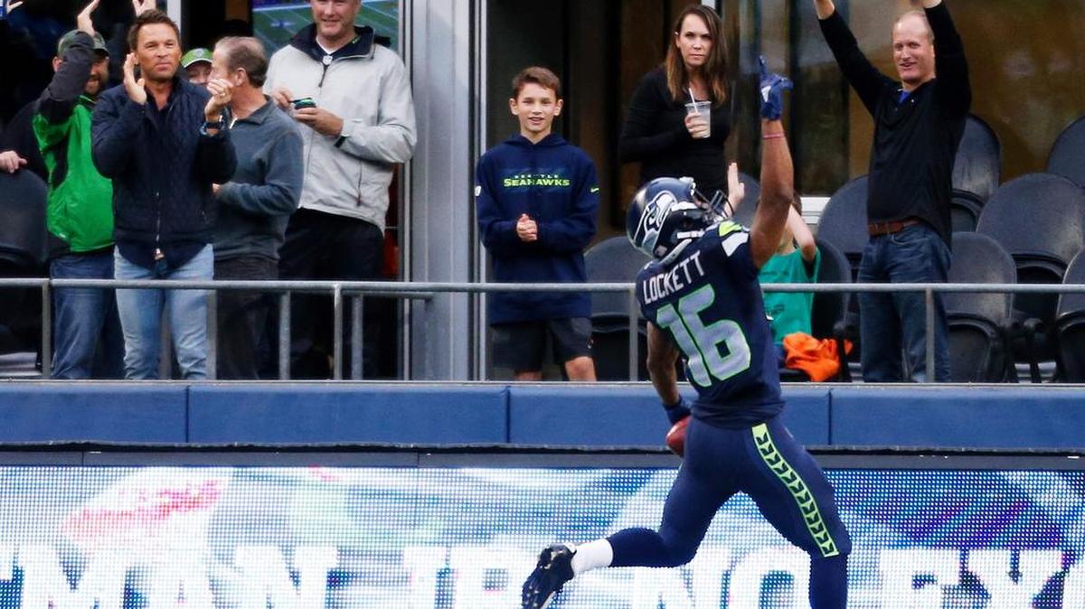 
Seattle Seahawks wide receiver Tyler Lockett celebrates with fans after he returned a kickeoff 103 yards for a touchdown against the Denver Broncos during the first half of a preseason NFL football game, Friday, Aug. 14, 2015, in Seattle.
