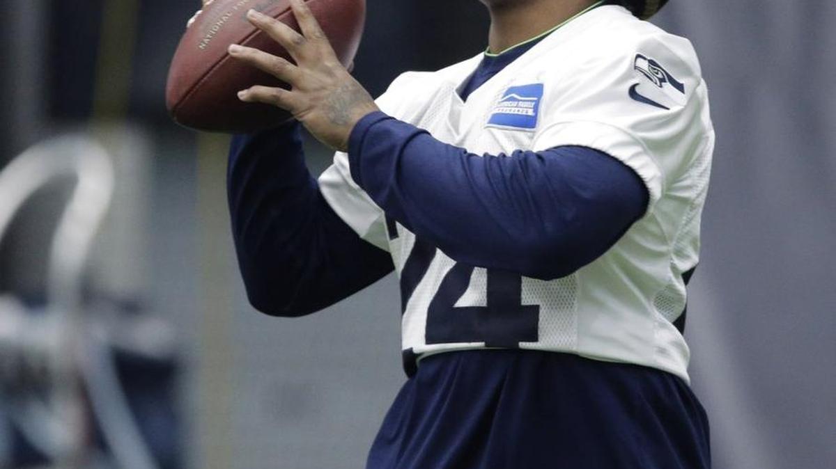 Seahawks running back Marshawn Lynch gnaws on a candy cane as he warms up before practice Wednesday at team headquarters in Renton. Lynch had been recovering in his native Bay Area since having abdominal surgery in November.