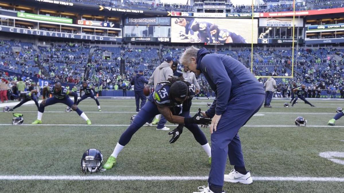 All-Pro cornerback Richard Sherman and Seahawks coach Pete Carroll, right, meet during pregame warmups before last weekend’s loss to Arizona at CenturyLink Field. Carroll had a team meeting before the game -- and after Sherman’s sideline blowup them challenge of a Seattle radio host in a press conference.