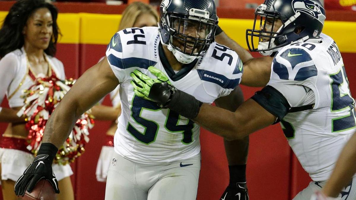 
Seattle Seahawks middle linebacker Bobby Wagner (54) celebrates his touchdown with teammate K.J. Wright (50) during the first half of an NFL football game against the Kansas City Chiefs at Arrowhead Stadium in Kansas City, Mo., Friday, Aug. 21, 2015.
