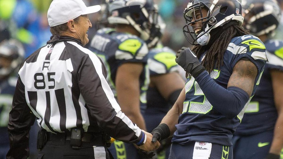 Seahawks All-Pro cornerback Richard Sherman suggests improved communication with officials, like this interaction with referee Ed Hochuli during a game in November 2014, would go a long way to improving the NFL’s officiating.