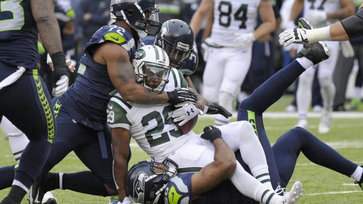 Seahawks Pro Bowl defensive end Michael Bennett (72), here tackling tackles Jets running back Matt Forte Sunday, got head butted after a play by New York guard Brian Winters. This week Winters is going through the NFL’s concussion protocol while Bennett enjoys a bye “on an ocean.”