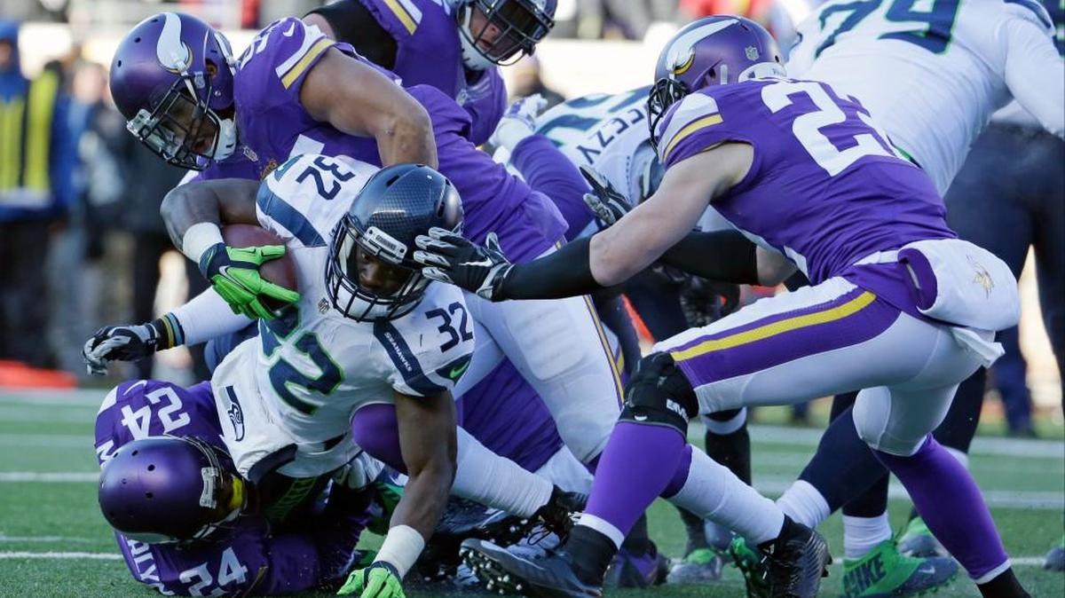 Seattle Seahawks running back Christine Michael (32) is tackled by Minnesota Vikings cornerback Captain Munnerlyn (24) during the second half of an NFL wild-card football game, Sunday, Jan. 10, 2016, in Minneapolis.