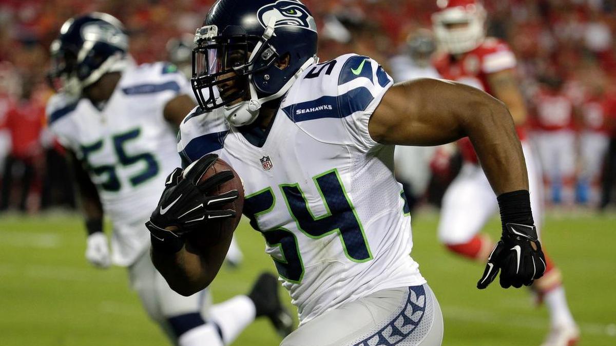 
Seattle Seahawks middle linebacker Bobby Wagner (54) runs for a touchdown after an interception during the first half of an NFL football game against the Seattle Seahawks at Arrowhead Stadium in Kansas City, Mo., Friday, Aug. 21, 2015.
