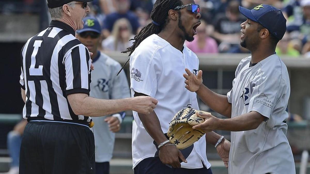 Richard Sherman, shown here playing around with former Seahawks teammate Golden Tate at Sherman’s celebrity softball game in 2013 in Tacoma, announced Monday Marshawn Lynch will be part of this year’s charity game at Safeco Field July 10.