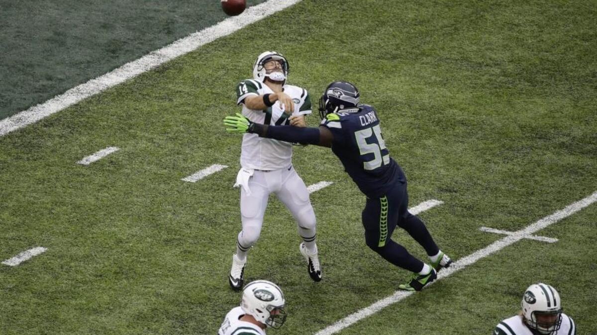 Frank Clark gets one of his two hits on New York Jets quarterback Ryan Fitzpatrick in Seattle’s last game on Oct. 2. Since then, Clark has injured his hamstring, according to the Seahawks’ practice report from Wednesday.