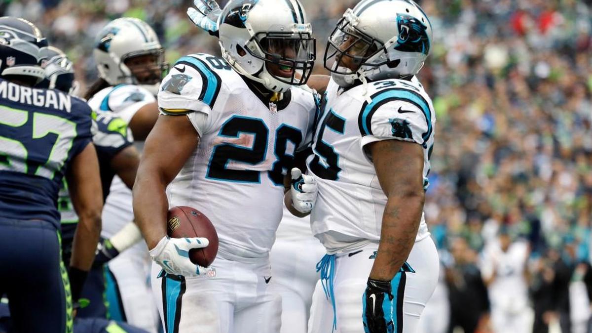 
Carolina Panthers running back Jonathan Stewart, (28) is greeted by teammate Mike Tolbert, right, after scoring a touchdown against the Seattle Seahawks in the second half of an NFL football game, Sunday, Oct. 18, 2015, in Seattle.

