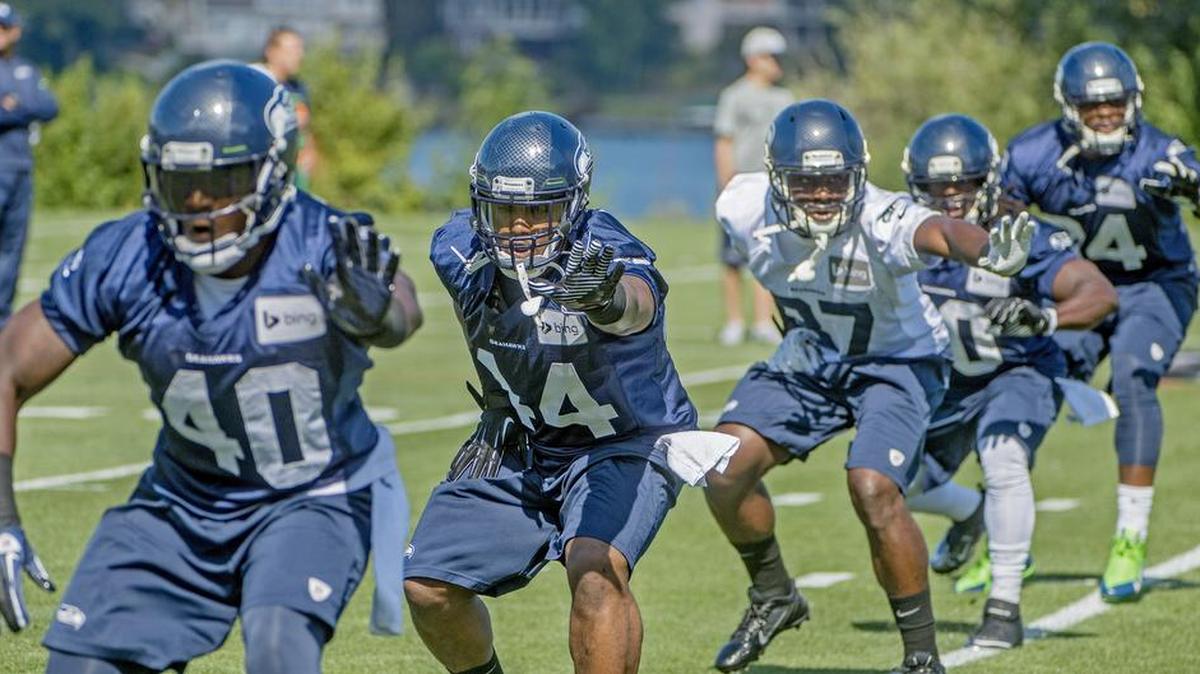 
Dion Bailey (37 in white) has for now taken over the No. 1 strong-safety job while starter Kam Chancellor’s holdout passes its 11th day and ninth practice of Seahawks training camp. 
