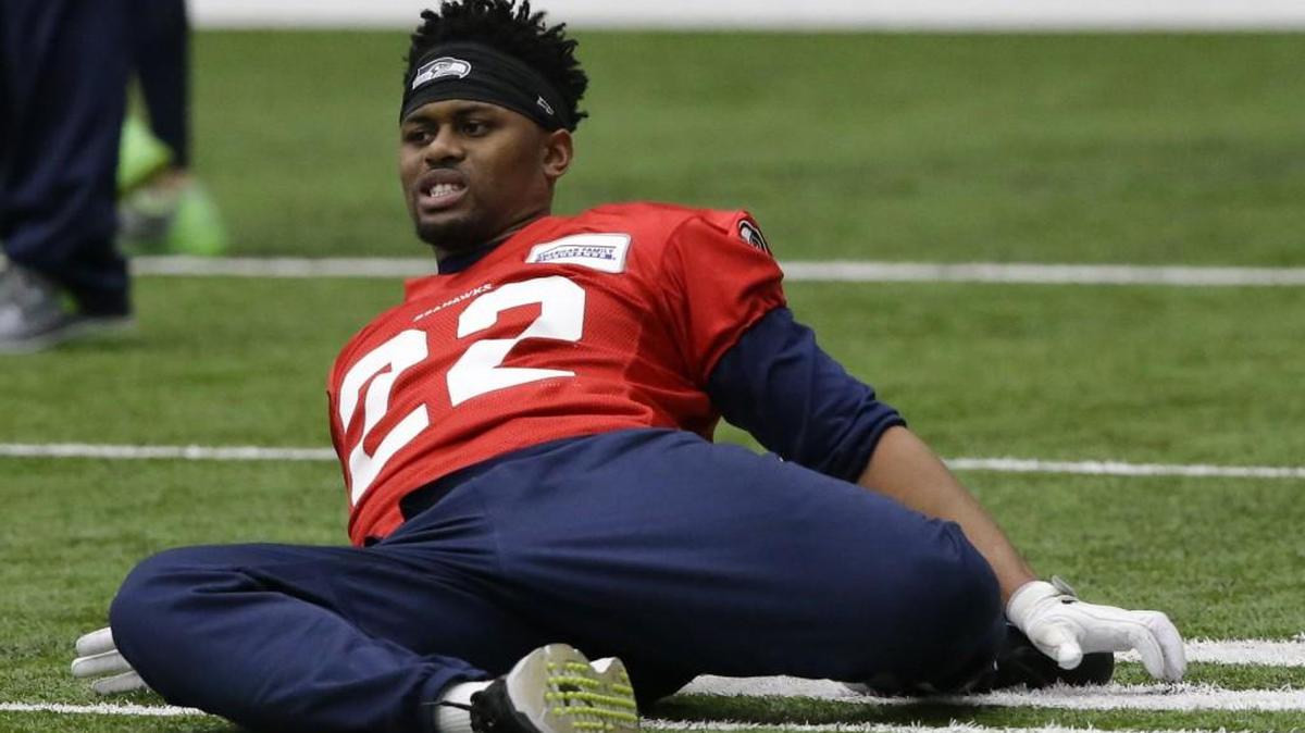 Running back C.J. Prosise stretches at the start of practice Tuesday at Seahawks headquarters. The team listed him as a limited participant Wednesday. These are the rookie third-round pick’s first practices since he broke his scapula Nov. 20. Coaches say his status for playing in Saturday’s divisional playoff game at Atlanta won’t be determined until the end of this week.
