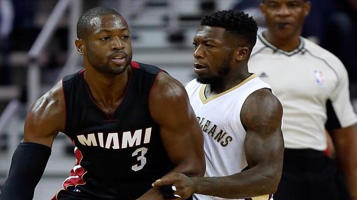 Could Nate Robinson, right, go from guarding basketball players such as Miami Heat guard Dwayne Wade to covering receivers in the NFL?