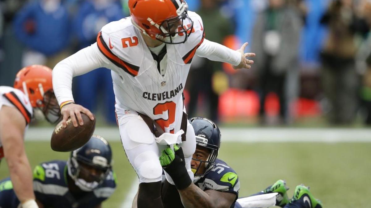 Seattle Seahawks' Bruce Irvin (51) grabs for Cleveland Browns quarterback Johnny Manziel in the first half of an NFL football game, Sunday, Dec. 20, 2015, in Seattle.