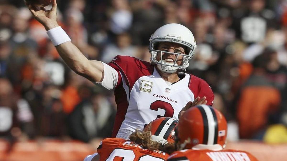 FILE - In this Nov. 1, 2015, file photo, Arizona Cardinals quarterback Carson Palmer (3) passes under pressure from Cleveland Browns linebacker Paul Kruger (99) in the first half of an NFL football game, in Cleveland.