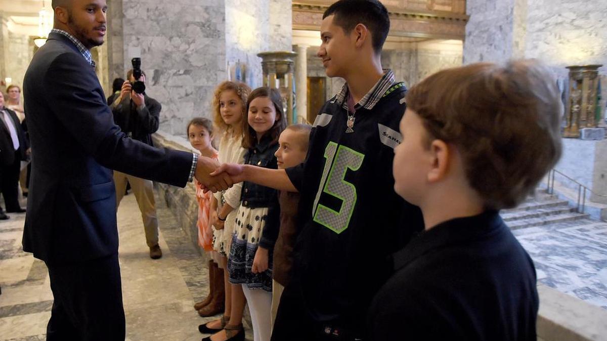 Seattle Seahawks wide receiver Jermaine Kearse greets Brian Trujillo, 13, of Bremerton before headlining a reception Monday at the State Capitol honoring Gold Star children and their families. The Lakes High School and UW alum grew up in a military family while his dad was stationed at JBLM and has started the 15 to 1: Jermaine Kearse Foundation to assist children in military families.