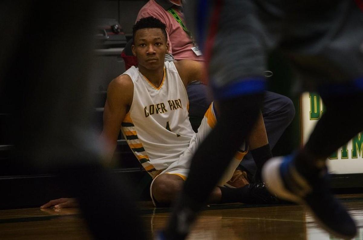 Clover Park High School basketball player Semaj Booker (#1) watches the action shortly before he goes back in at the Clover Park Warrior’s playoff game against the Washington Patriots at Foss High School in Tacoma, WA, Monday, February 15, 2016.