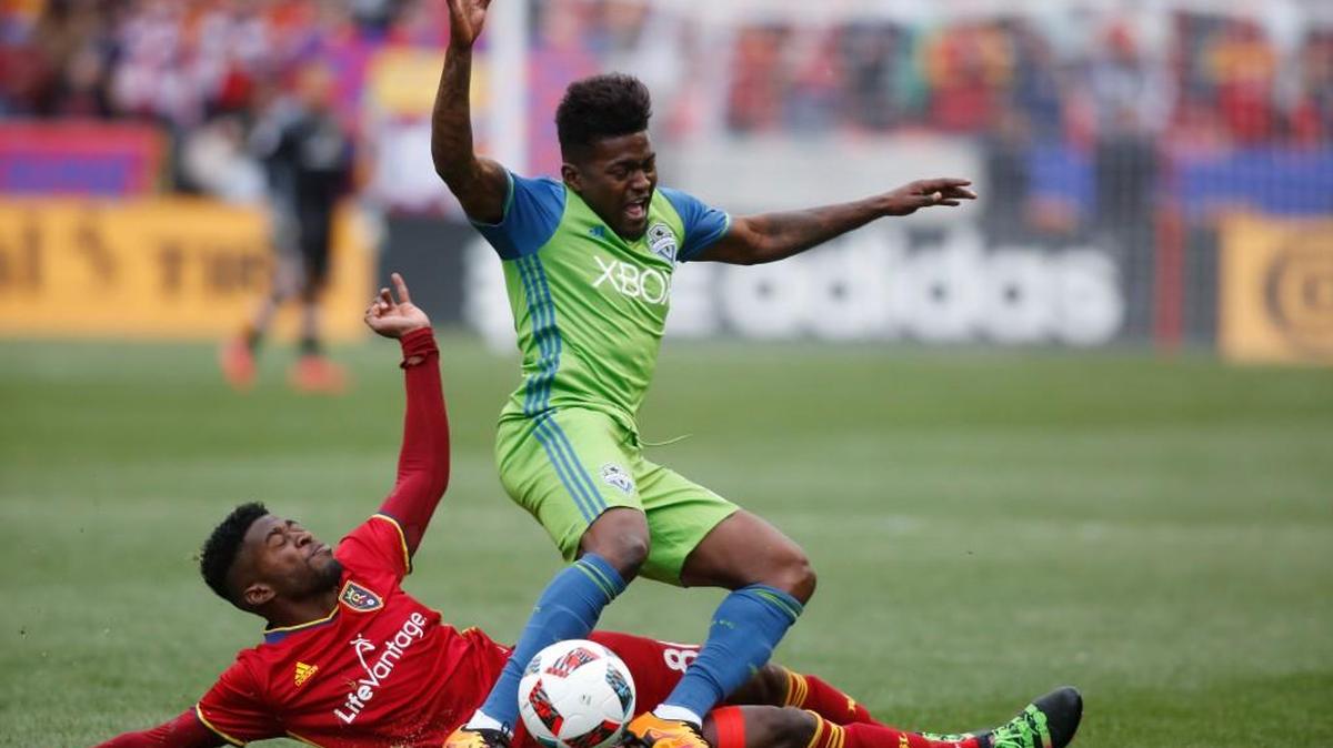 Seattle Sounders forward Darwin Jones, top, is knocked off his feet by Real Salt Lake forward Olmes Garcia, bottom, during the second half Saturday in Sandy, Utah.
