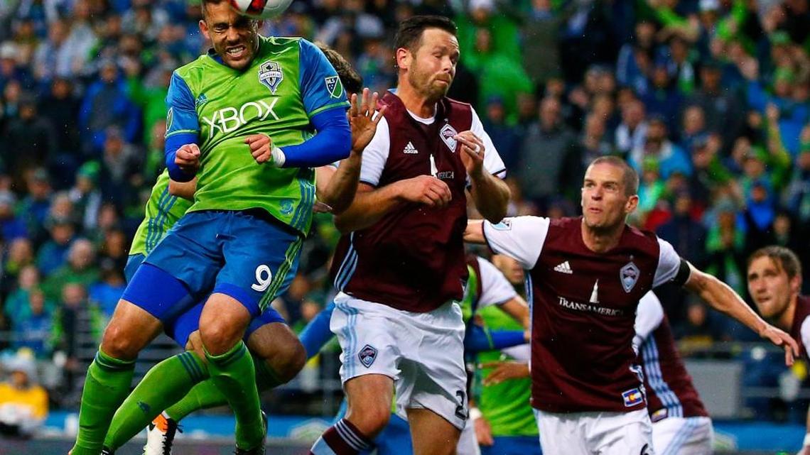Seattle’s Herculez Gomez (9) heads the ball next to Colorado’s Bobby Burling (23) during an MLS soccer match Saturday, May 21, 2016, in Seattle. Colorado won 1-0.
