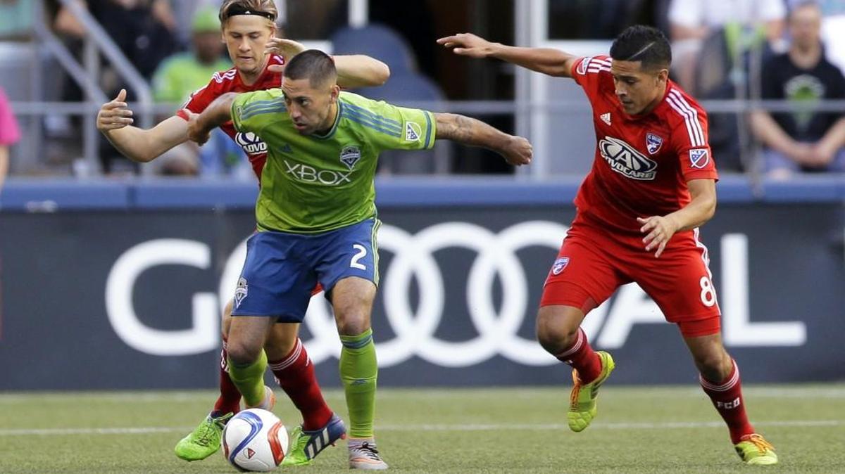 Seattle’s Clint Dempsey (2) tries to hold off FC Dallas' Walker Zimmerman, left, and Victor Ulloa, right, during the Sounders’ 3-0 win at CenturyLink Field on June 13. Seattle faces Dallas in the first leg of a Western Conference semifinal this weekend after a win and a draw in the regular season.