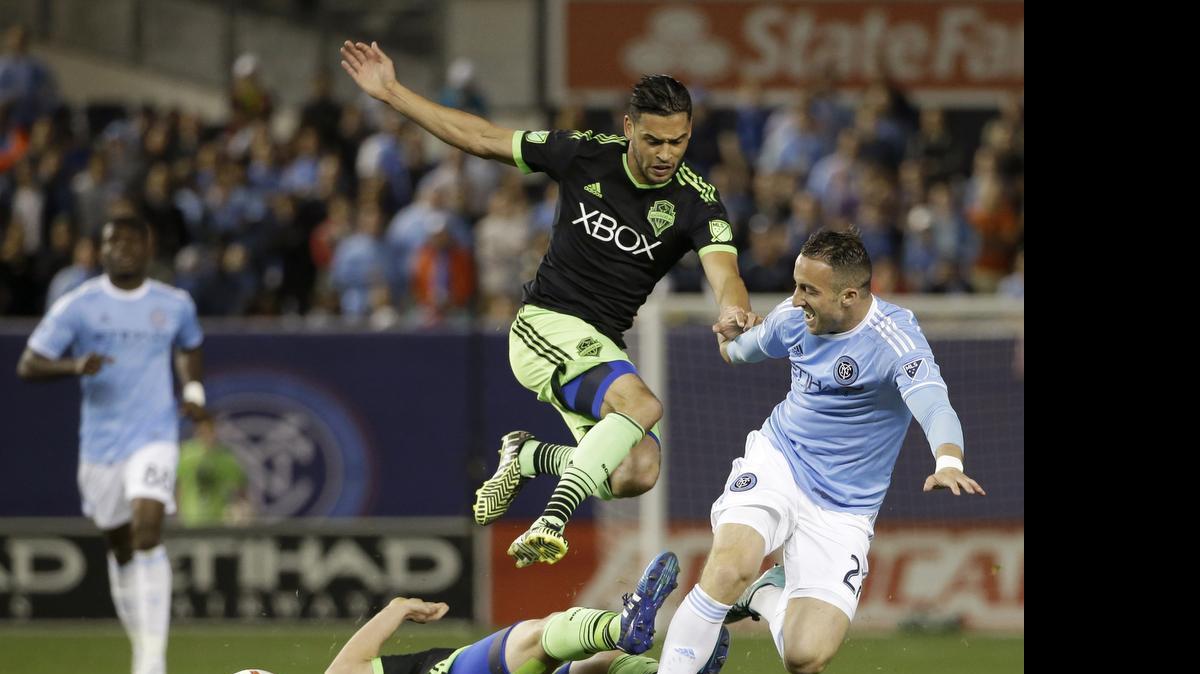 
Seattle’s Lamar Neagle, left, and New York City FC's Pablo Alvarez chase the ball during an MLS soccer game May 3 in New York. Neagle, who attended Thomas Jefferson High in Federal Way, was traded to the Montreal Impact in 2012 and returned to the Sounders in 2013. 
