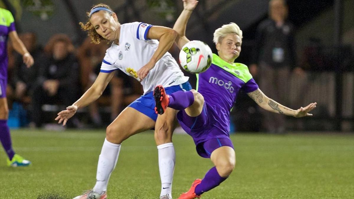FC Kansas City midfielder Lauren Holiday, left, and Seattle Reign FC midfielder Jessica Fishlock collide during the first half of the NWSL soccer championship match Oct. 1 in Portland. Kansas City won, 1-0.