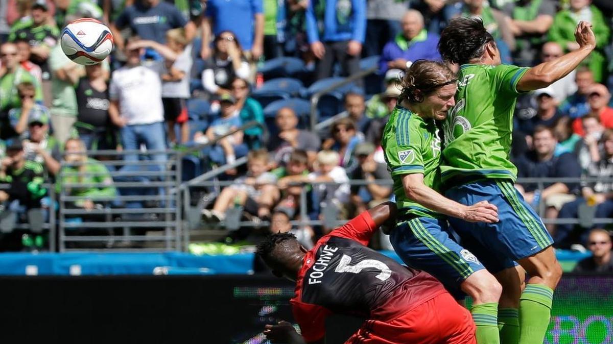
Sounders forward Nelson Valdez, right, and midfielder Erik Friberg, center, fight for the ball Sunday against Portland. With Clint Dempsey close to returning, Valdez’s starting spot may be in jeopardy.
