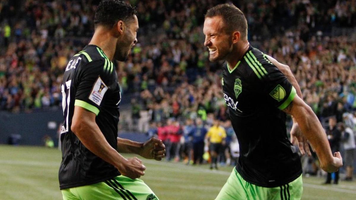 
Seattle Sounders midfielder Lamar Neagle, left, celebrates with Chad Barrett after Neagle scored a goal against the Vancouver Whitecaps during the first half of a CONCACAF Champions League soccer match, Wednesday, Sept. 23, 2015, in Seattle.
