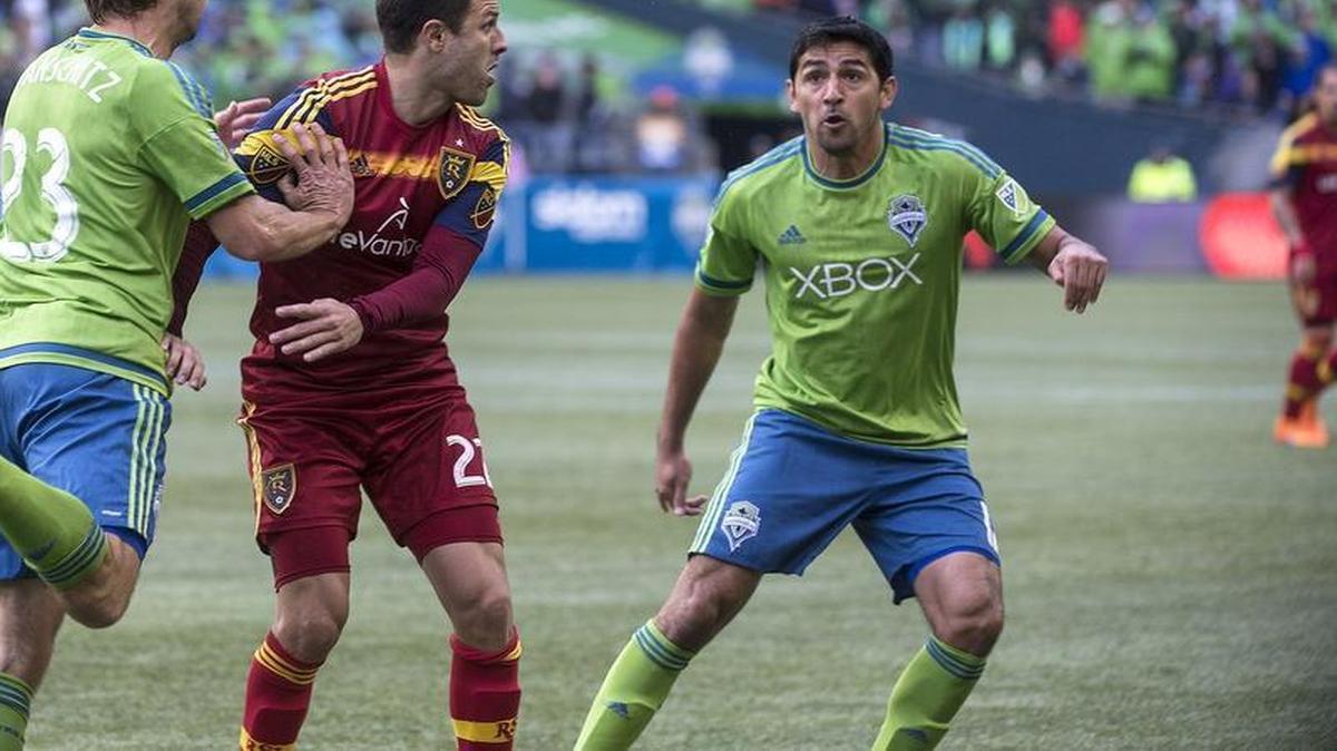 Sounders defenders Andreas Ivanschitz left, and Leo Gonzalez apply pressure against Real Salt Lake on Sunday. Thanks to the Sounders’ 3-1 victory, they will play host to the Los Angeles Galaxy in the playoffs on Wednesday.