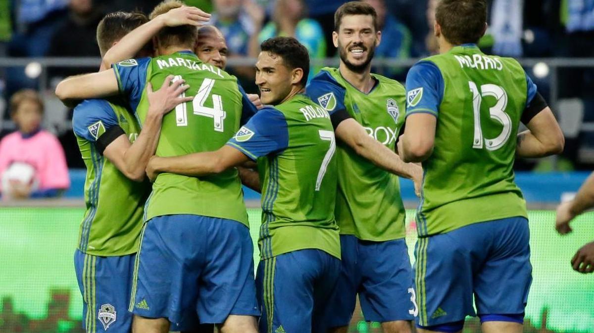 Seattle’s Chad Marshall (14) is congratulated by teammates after he scored against Philadelphia on Saturday during the first half.