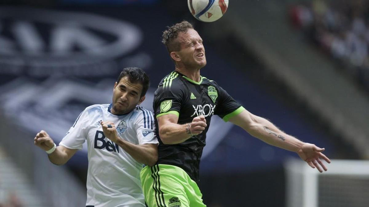 
Sounders' Chad Barrett and Whitecaps' Steven Beitashour compete for header during the teams’ MLS meeting in May.

