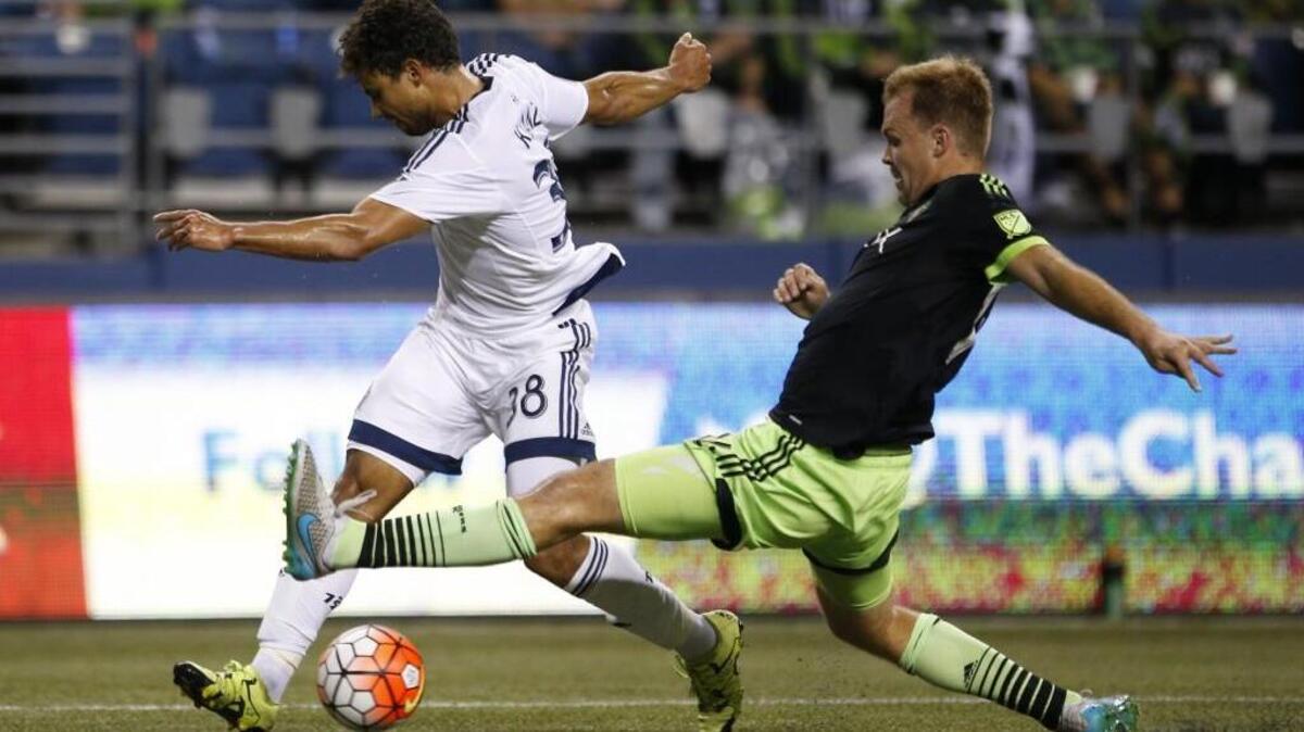 Sounders defender Chad Marshall, right, goes for the steal against Whitecaps midfielder Kianz Froese during a CONCACAF Champions League match in September. Cascadia rivals Seattle and Vancouver will meet Feb. 3 in the Sounders’ 2016 preseason opener.