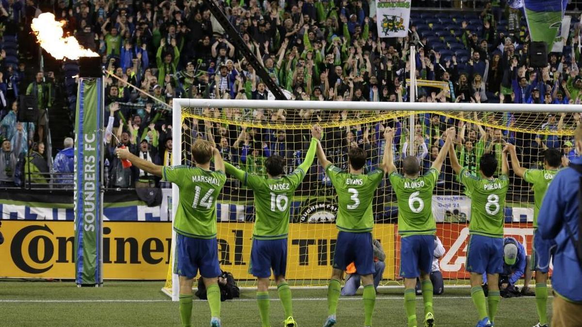 
Seattle Sounders players cheer for their fans after beating Toronto FC 2-1. 
