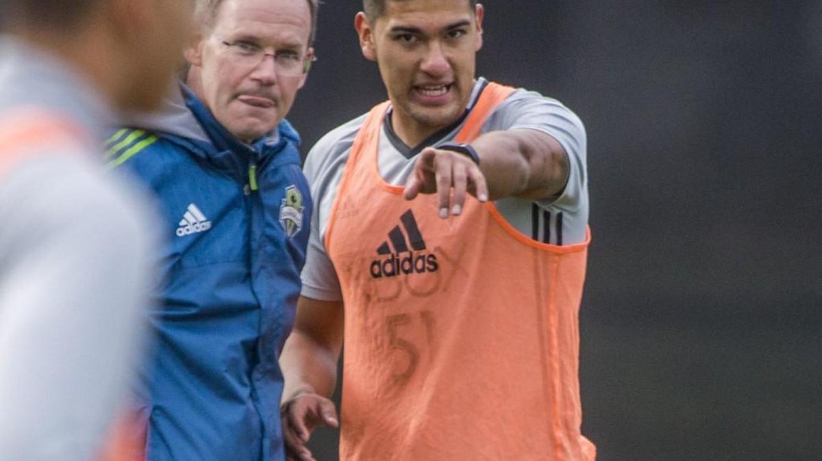 Seattle Sounders Tony Alfaro talks with a coach at training camp in Tukwila.