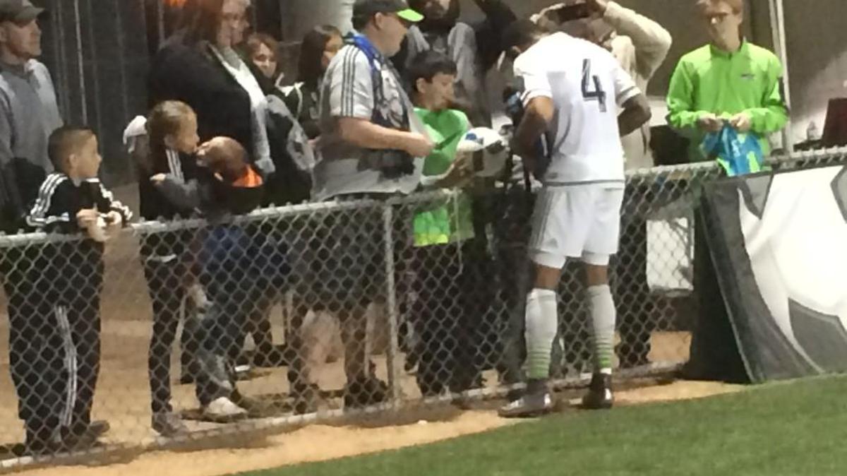 Seattle defender Tyrone Mears signs autographs for fans after the Sounders’ 2-1 friendly loss to Portland on Saturday in Tucson, Arizona.
