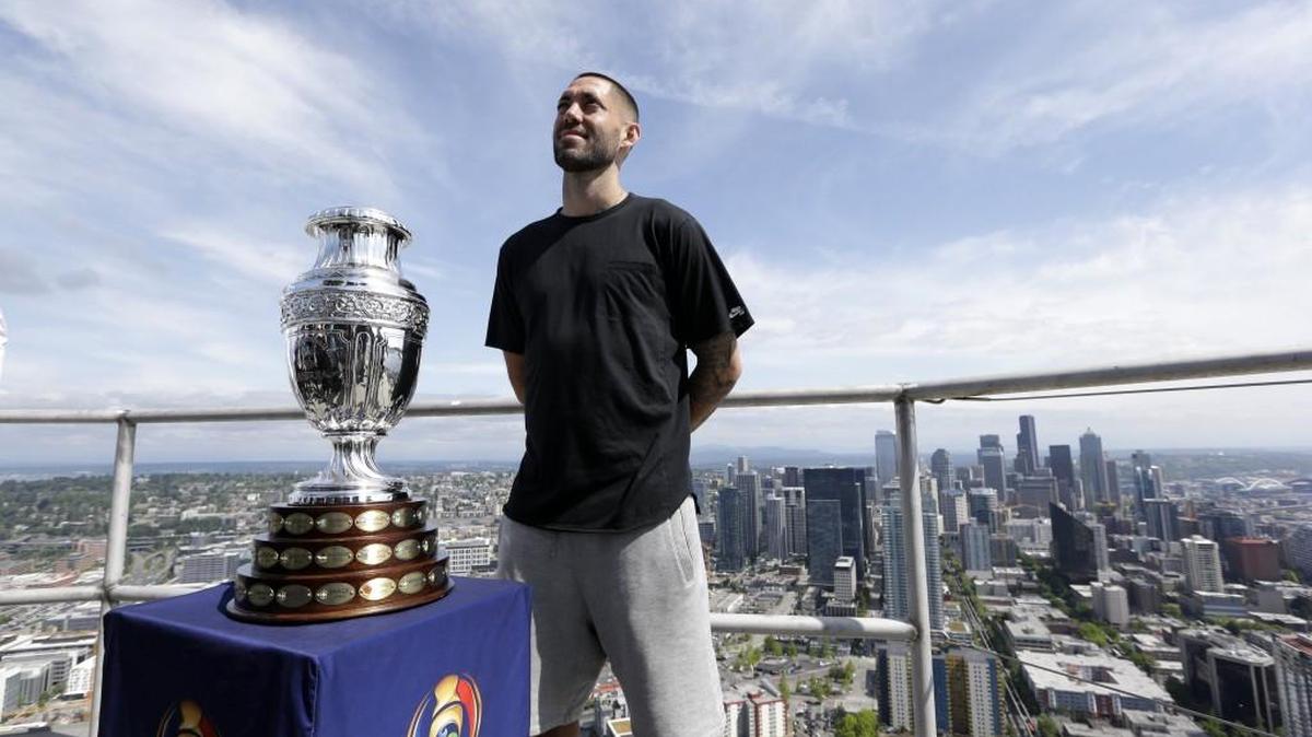 Seattle Sounders' Clint Dempsey poses with the Copa America Centenario trophy as he stands atop the Space Needle earlier this month.