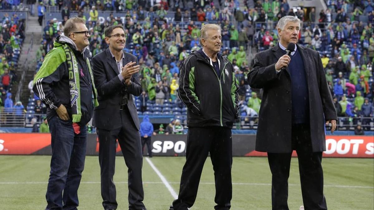 Seattle Sounders owners Drew Carey, Adrian Hanauer and Joe Roth -- third from left -- with coach Sigi Schmid.