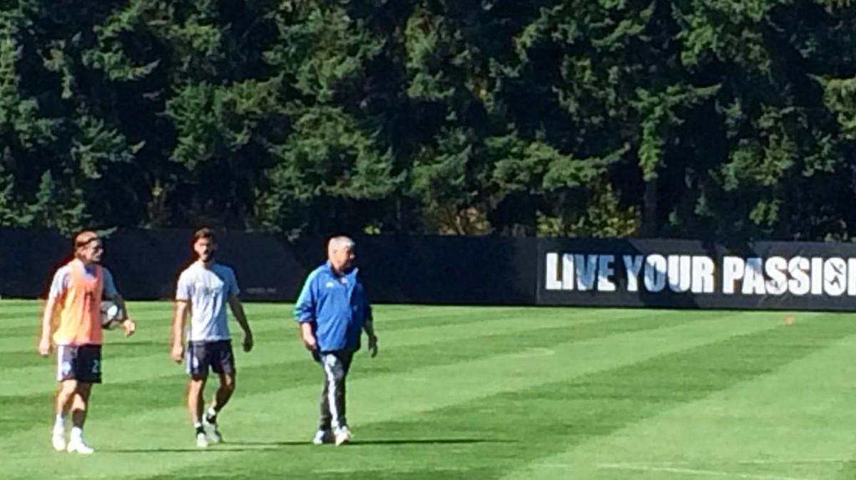 
Sounders coach Sigi Schmid, right, back at training at Starfire today with players Erik Friberg and Brad Evans.
