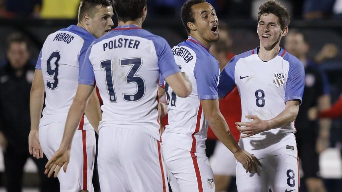 USA forward Jordan Morris (9) celebrates with teammates after Colombia own goal during Olympic qualifying soccer match Tuesday in Frisco, Texas.