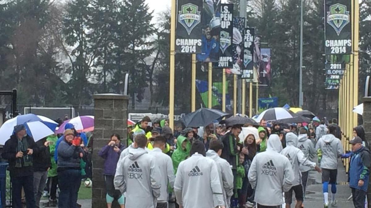 A crowd of supporters greet the Sounders as they turned out for their first training session of the new season Saturday at Starfire in Tukwila.