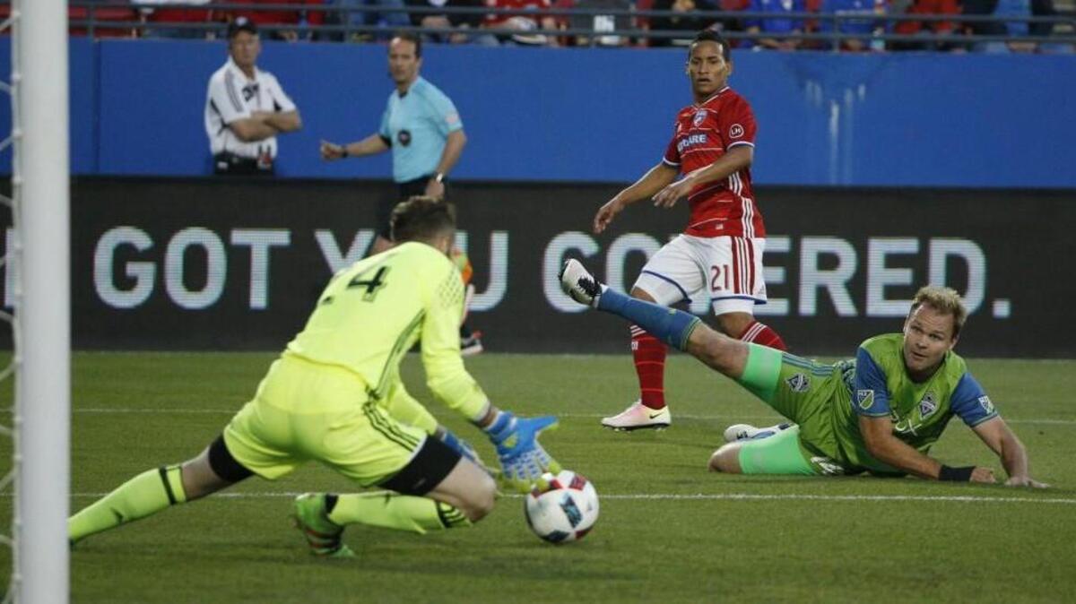 Seattle Sounders goalkeeper Stefan Frei and Seattle Sounders defender Chad Marshall stop a shot by FC Dallas midfielder Michael Barrios (21) during their MLS match Saturday at Frisco, Texas.