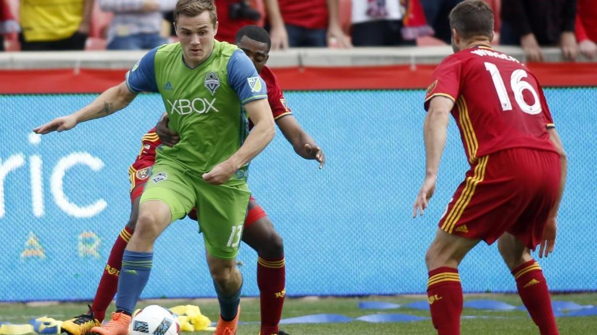 Seattle Sounders' Jordan Morris (13) works against Real Salt Lake's Aaron Maund, back, during the first half of an MLS soccer game on Saturday in Sandy, Utah.