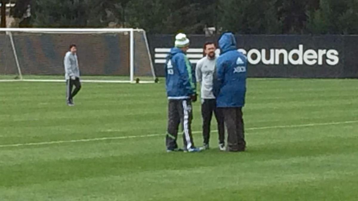 Former U.S. international forward Herculez Gomez talks after training today with Seattle Sounders coach Sigi Schmid (left) and general manager Garth Lagerwey.