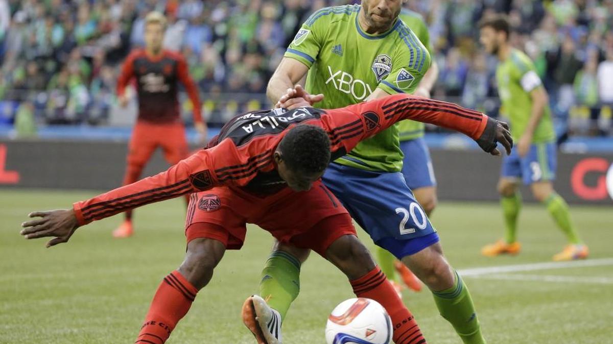 Seattle Sounders' Zach Scott, right, battles for the ball against Portland Timbers last season.