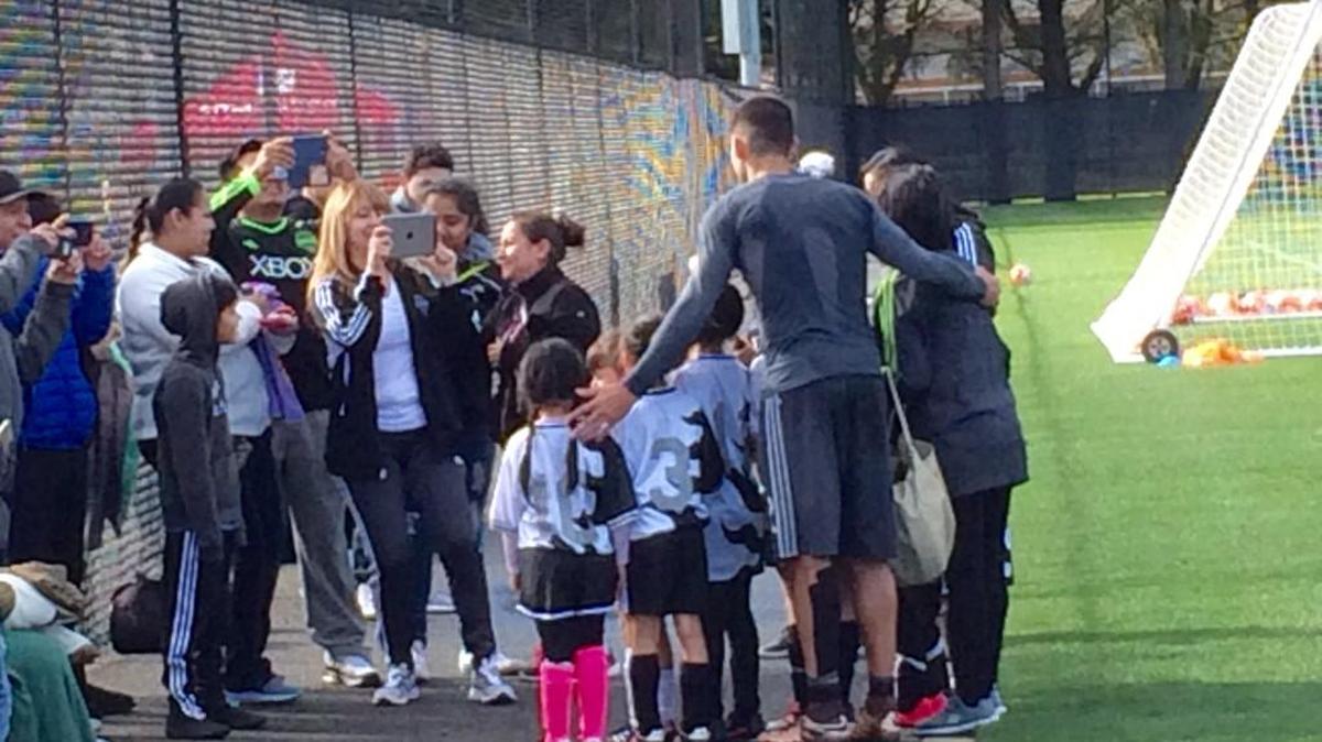 Sounders star forward Clint Dempsey poses with a youth team after training Saturday at Starfire Sports Complex in Tukwila.