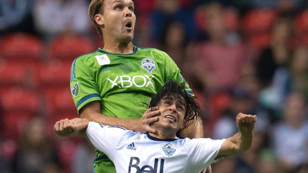 
The Sounders’ Chad Marshall, back, and the Whitecaps’ Mauro Rosales vie for the ball during Saturday’s match in Vancouver. The teams square off again Wednesday night at CenturyLink Field.

