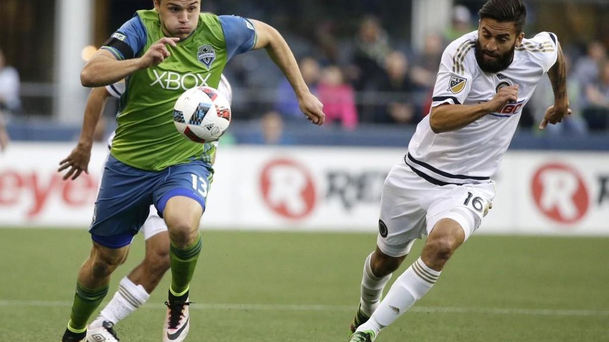 Sounders Jordan Morris, left, drives with the ball as Philadelphia 's Richie Marquez pursues during the first half of an MLS soccer match.