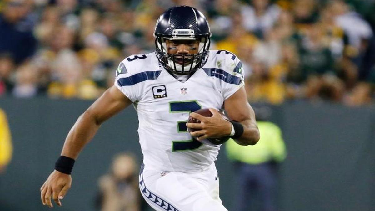 
Seattle Seahawks' Russell Wilson runs past Green Bay Packers' Nick Perry during the second half of an NFL football game Sunday, Sept. 20, 2015, in Green Bay, Wis.
